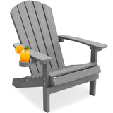 A gray slatted Adirondack-style outdoor chair with wide armrests and a built-in cup holder on the left armrest, holding an orange drink with an orange slice garnish, shown on a white background.
