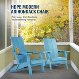 Two blue Adirondack chairs on a patio with autumn foliage in the background.