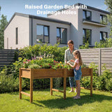 Woman and child tending to plants in a raised garden bed with drainage holes in a backyard setting.