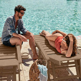 Man and woman sitting by a pool, enjoying each other's company.