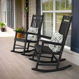 Two black rocking chairs with zebra print cushions on a porch.