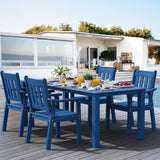 Blue outdoor dining set with table and chairs on a wooden deck, featuring a modern house and pool in the background.